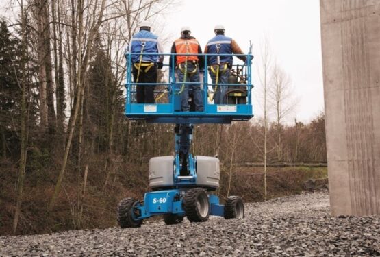 Three individuals on a moving elevating work platform (MEWP)