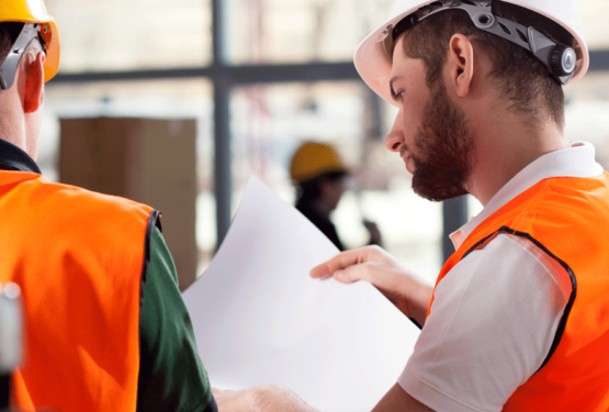 Men looking at worksheet