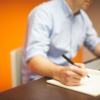 Man writing in workbook