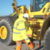 man climbing stops on plant machinery