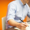 Man writing in notebook